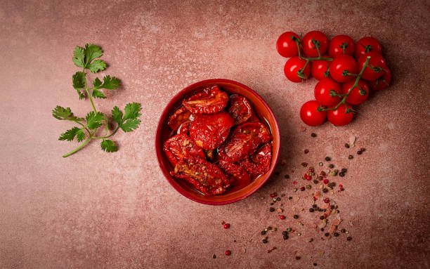 istock dried tomatoes, in a bowl, top view, on a brown background, 1990336504