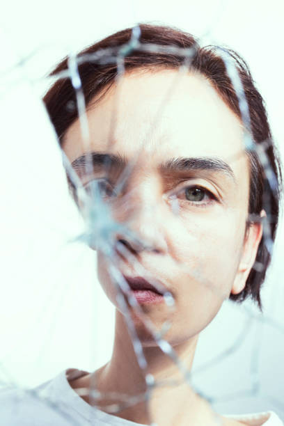istock Depressed Woman in Broken Mirror 1990361627
