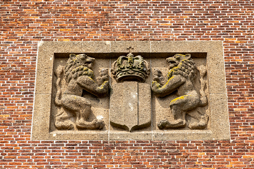 Plaque with Dutch lions on front facade of former city hall of Medemblik, Noord-Holland, Netherlands