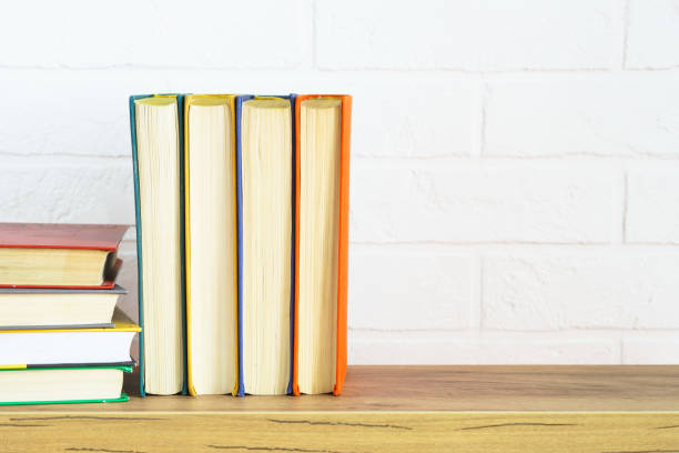 istock Bookshelf with colored books and green plant 1990409801