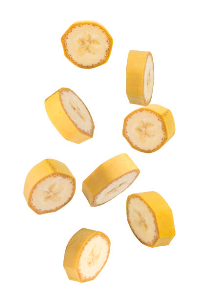 istock Flying fruits. Falling sliced banana fruit isolated on white background with clipping path as package design element. 1990413693