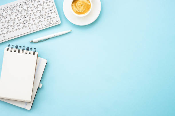 istock Office table desk with laptop, notepad, pen and cup of coffee. 1990416937