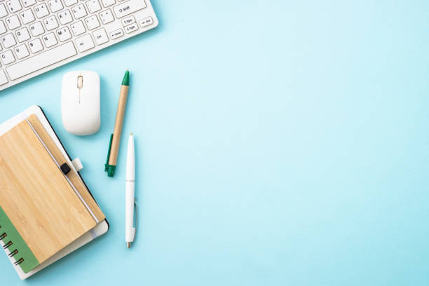 istock Office table desk with laptop, notepad and pen. 1990416950
