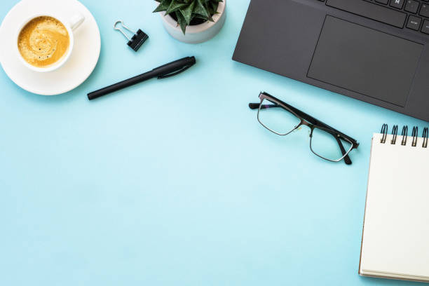 istock Office table desk with laptop, headphones, notepad and pen. 1990420754