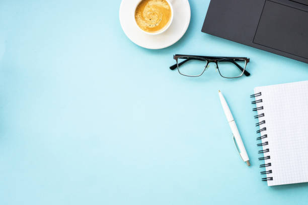 istock Office table desk with laptop, notepad, pen and cup of coffee. 1990422912