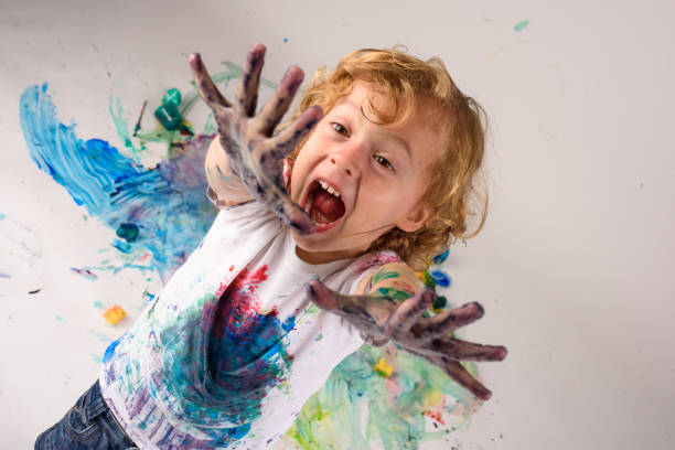 istock Astonished boy looking at dirty hands 1990446581