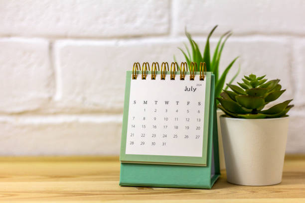 istock Desk calendar for July 2024 on the desktop. 1990447104