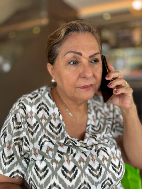 istock Senior Hispanic woman on mobile phone call 1990452239
