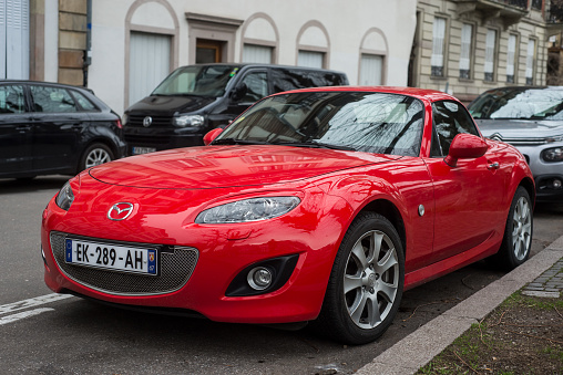 Strasbourg  France - 3 February 2024 - Front view of vintage red Mazda MX5 parked in the street