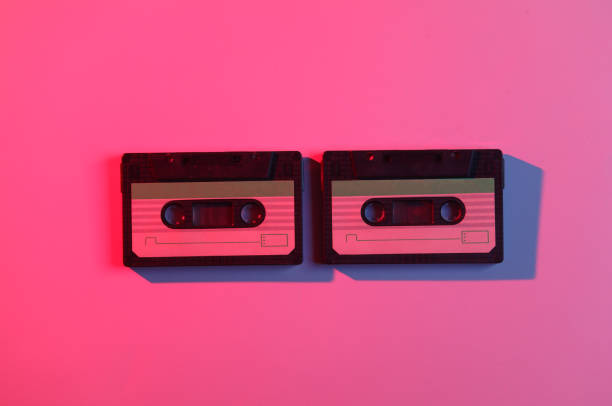 istock Audio cassettes in neon light. Retro wave, 80s 1990514703