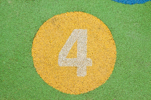 Number four in a multicolored rubber outdoors children's playground.