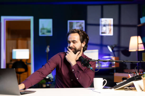 istock Man reading from laptop in studio, looking perplexed at recent news headlines 1990557032