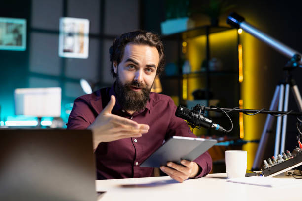 istock Portrait of content creator analyzing tablet, doing influencer marketing 1990564119