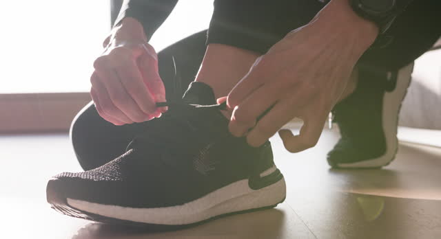 Jogger tightens shoelaces before run