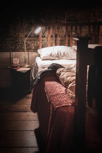 istock Angle Poise Reading Light Over A Vintage Bed With A Quilt 1990590887