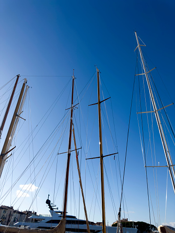 Close up mast sailboats over sky at marina in St Tropez, France