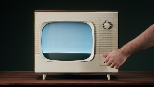 Old television with grey interference screen. Close-up of vintage tv, nostalgia, switching channels.