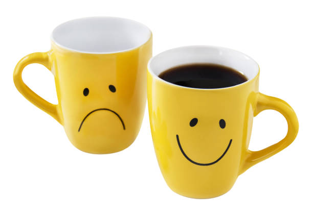 istock Two yellow cups and coffee isolated on white  background 1990648652
