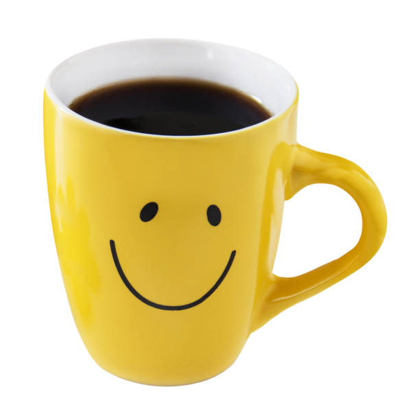 1 Yellow cup of coffee and smile isolated on white background 1 Yellow cup of coffee and smile isolated on white background tasse café stock pictures, royalty-free photos & images