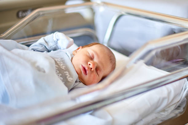 istock Newborn baby sleeping in its hospital crib 1990651246