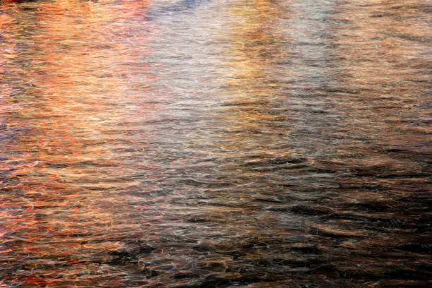 Background created by city colors falling on the sea