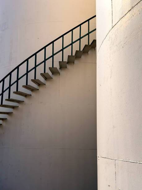 istock Large industrial cylinder storage tanks and spiral staircase 1990694223
