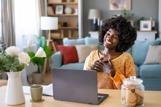 istock Young woman chatting with friends using her laptop 1990702494