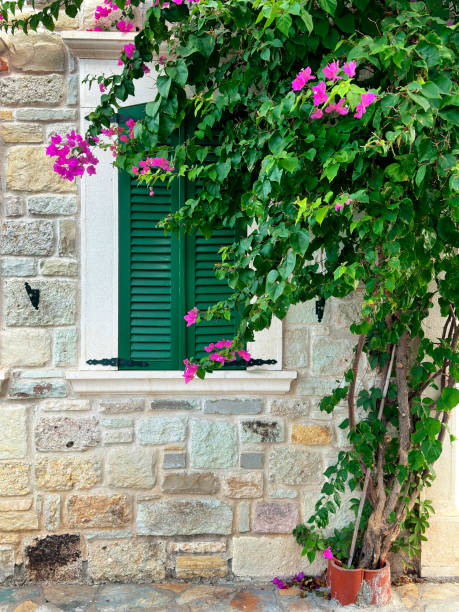 istock Close up window with wooden shutter from stone house 1990706624