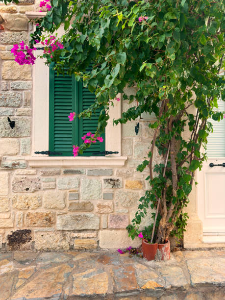 istock Close up window with wooden shutter from stone house 1990706635