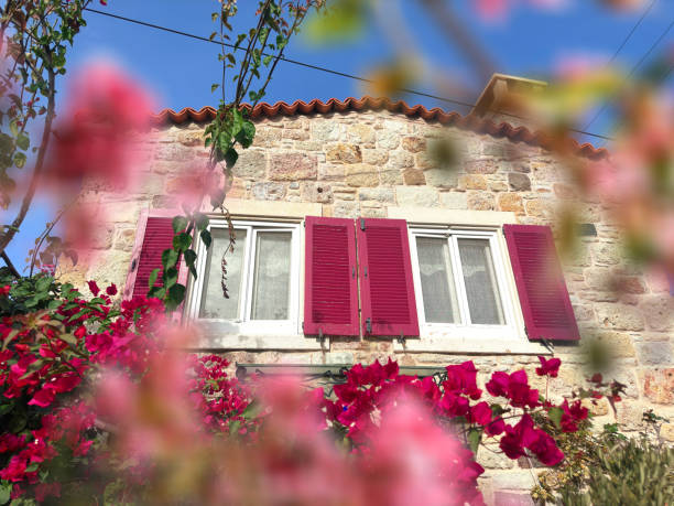 istock Close up window with wooden shutter from stone house 1990708203