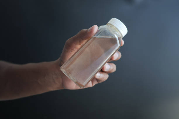 istock holding dirty bottle of water 1990711865