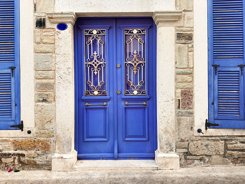 Traditional powder blue painted house facade and door in the historical Medina of Chefchaouen, Morocco.