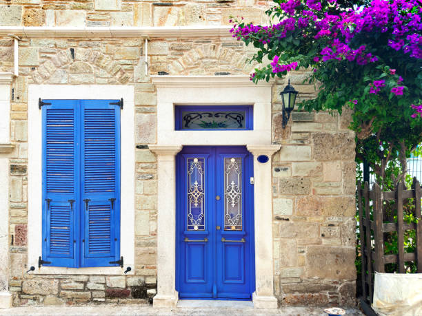 istock Old stone house exterior with blue front door and window 1990718133
