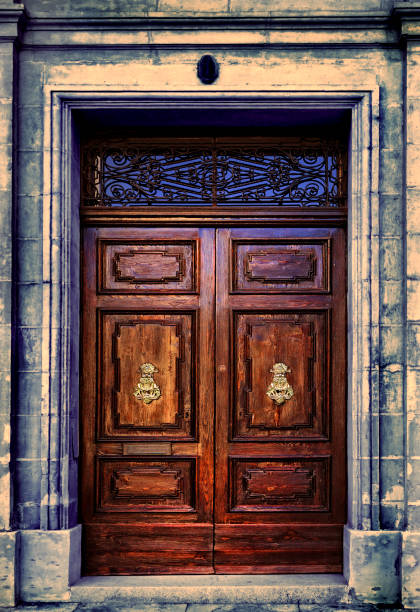 istock Old wooden brown front door with door knocker 1990719692