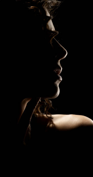 istock Sensual Profile Silhouette Portrait on Dark Background 1990740912