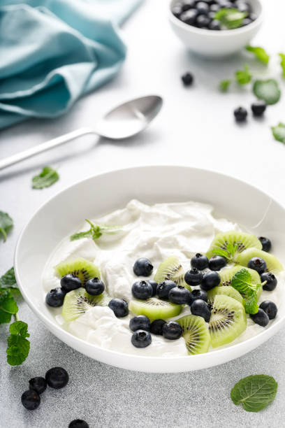 istock White plain greek yogurt with fresh blueberries and kiwi fruit 1990748713