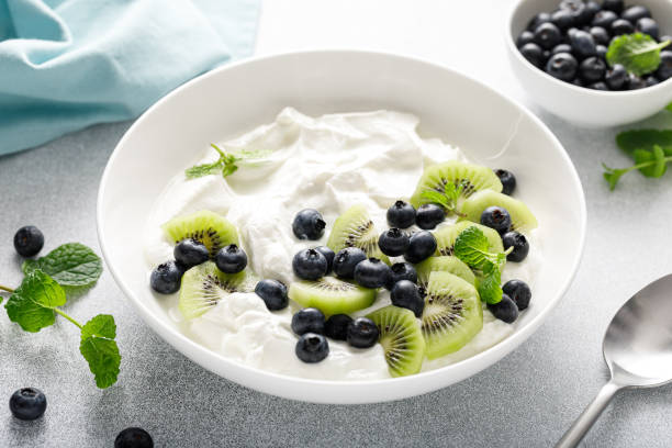 istock White plain greek yogurt with fresh blueberries and kiwi fruit 1990748720