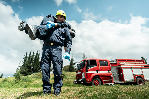 Portrait of paramedic carrying an accident victim on his shoulders