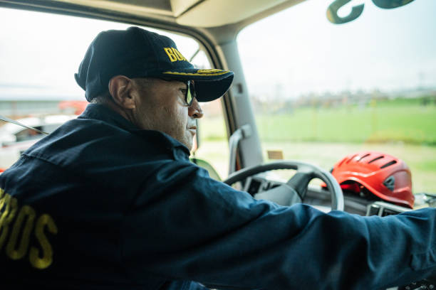 istock Mature fireman driving a fire truck 1990757657