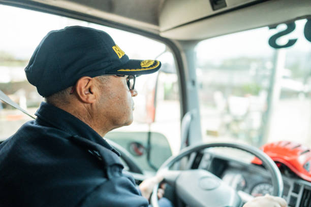 istock Mature fireman driving a fire truck 1990757661
