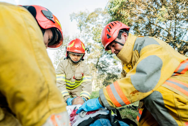 istock Firefighters helping a car accident victim 1990758176