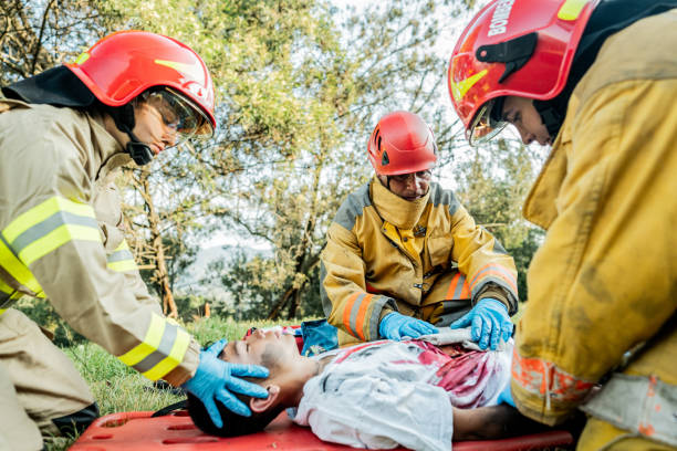 istock Firefighters helping a car accident victim 1990758180