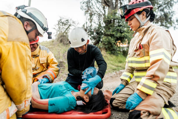 istock Firefighters helping a car accident victim 1990758694