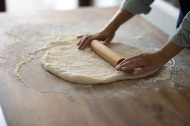 istock Female hands are kneading dough 1990778898