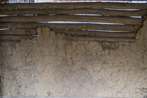 Sunja, Croatia, April 22,2023 : Facade of mud and straw on old wooden house.