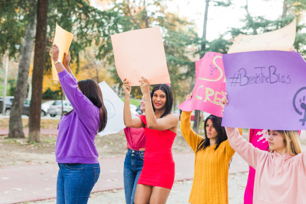istock IWD multiracial group protestors, manifestation for equality feminism rights. Activist with boards 1990785238