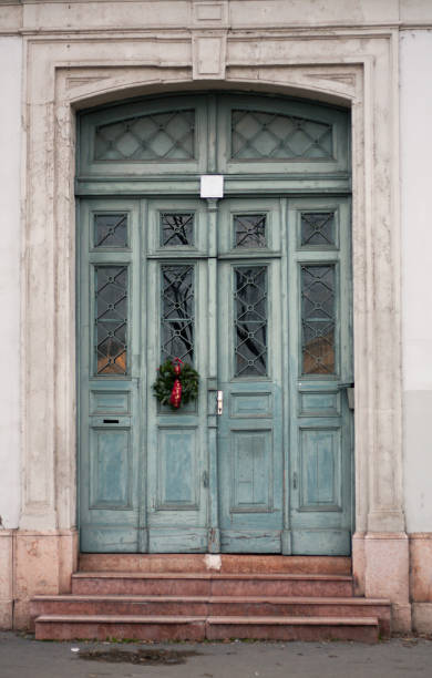 istock a mint colored door with a Christmas wreath on the building 1990786831