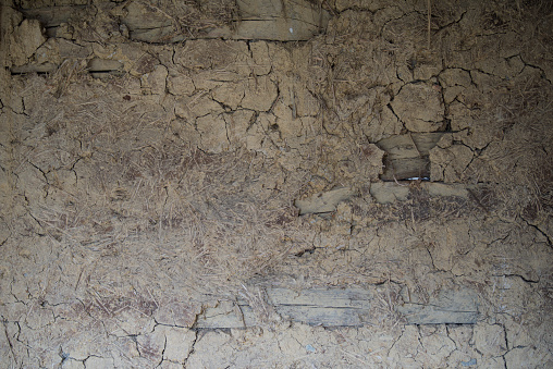 Sunja, Croatia, April 22,2023 : Facade of mud and straw on old wooden house.