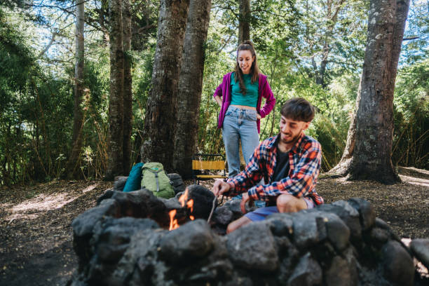istock Friends doing a bonfire at a camp in the forest 1990824800