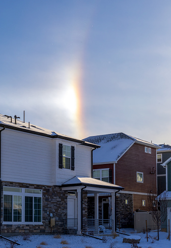 Aurora, Colorado - January 13, 2024: Sun Halo over the houses. Sun halo also known as sun bow or sun dog